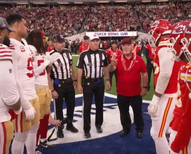 coach bobby watson wears a double portion supply cap during the super bowl 58 coin toss