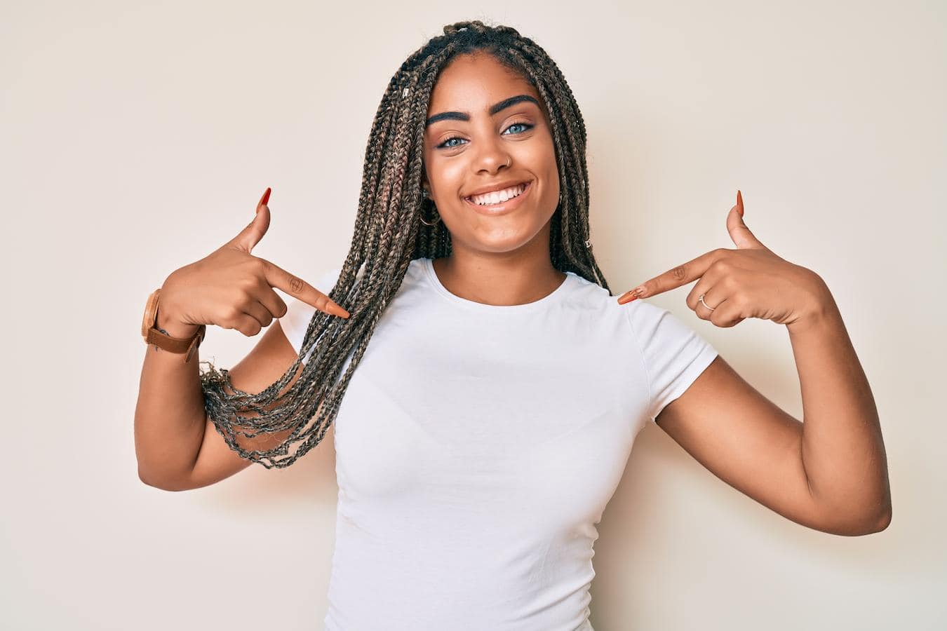 a girl pointing at a white t shirt she's wearing good company swag important best company swag items tech accessories company swag stores